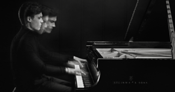 Black and white image of Jaeden Izik-Dzurko playing the piano
